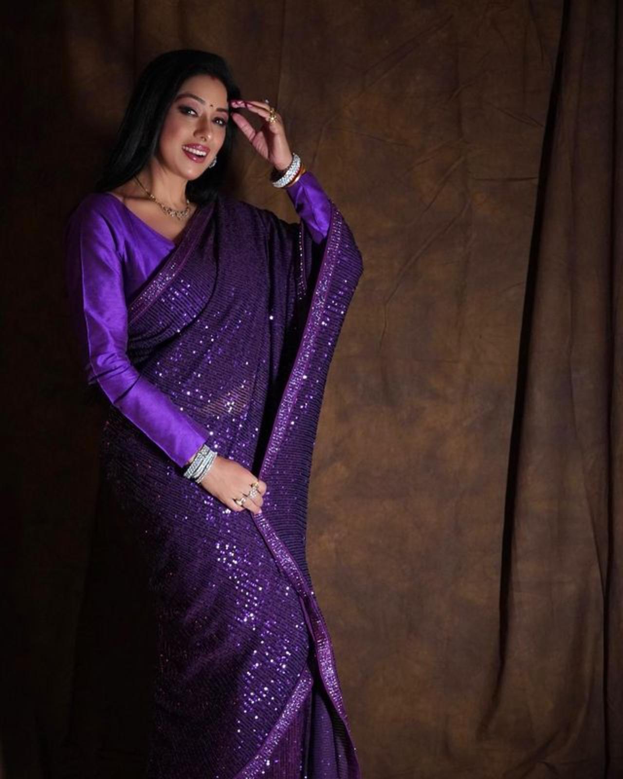 Rupali Ganguly looks stunning in this purple sequin saree that she has donned with a plain full sleeves matching blouse 